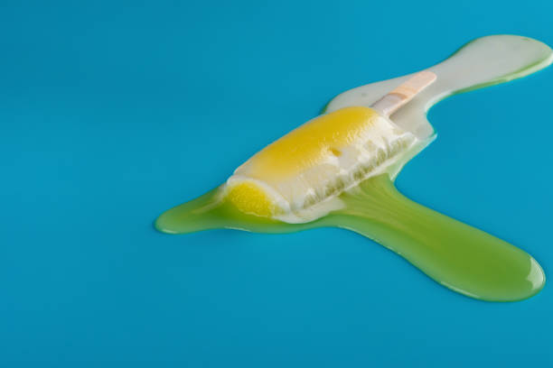 istock side view yellow popsicle in a melting process on blue background 1019252390