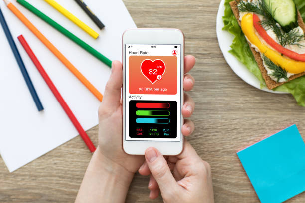 istock Female hands holding phone with app health tracking activity screen 1019259686