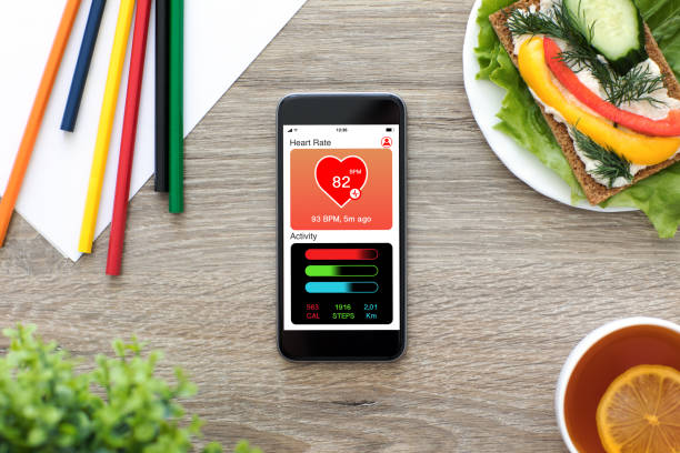 istock Phone with app health tracking activity screen on wooden table 1019259782