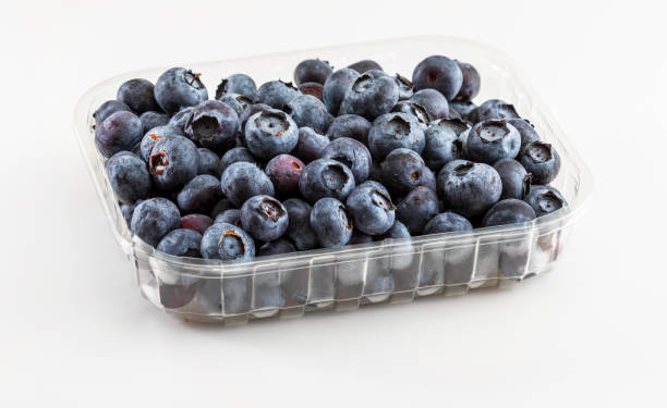istock Fresh and raw blueberries in plastic tub. Isolated and on white background. 1019262512