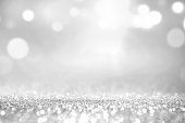 White silver glitter and grey lights bokeh abstract background.