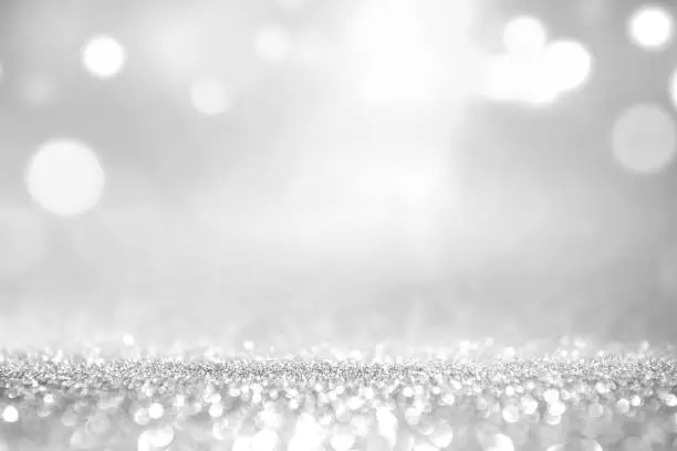 Photo of White silver glitter and grey lights bokeh abstract background.