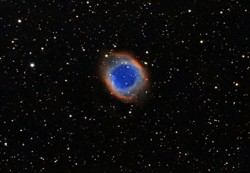The Helix Nebula, also known as The Helix, NGC 7293, is a large planetary nebula (PN) located in the constellation Aquarius. Discovered by Karl Ludwig Harding, probably before 1824, this object is one of the closest to the Earth of all the bright planetary nebulae. The estimated distance is about 215 parsecs (700 light-years). The Helix Nebula has sometimes been referred to as the \