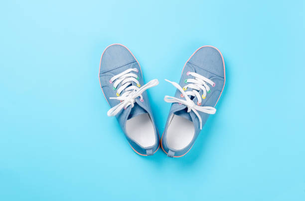 istock A pair of blue canvas sneakers on light blue background 1019274170