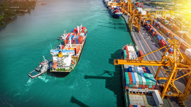 istock Logistics and transportation of Container Cargo ship and Cargo plane with working crane bridge in shipyard at sunrise, logistic import export and transport industry background 1019283264
