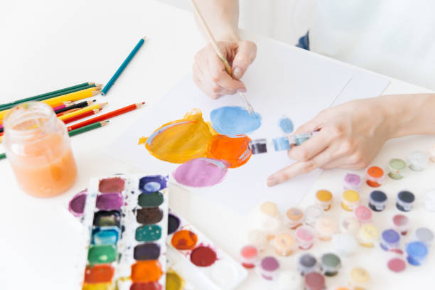 istock Pretty smiling young woman drawing a picture 1019296064