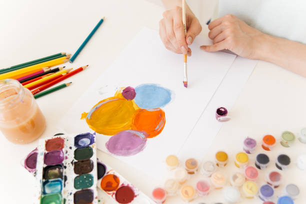 istock Pretty smiling young woman drawing a picture 1019296122