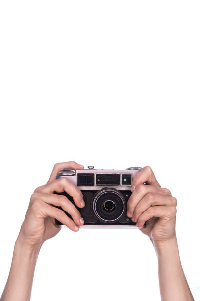 istock female hands hold vintage camera on white background 1019303194