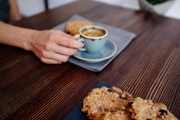 istock Cup of coffee and cookies in hand. 1019306182