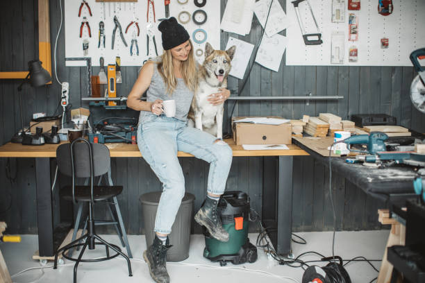 istock Women in workshop with her pet dog 1019314720