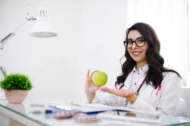 istock Nutritionist woman with green apple 1019329272