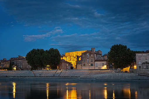 Night panoramic view of the French city of Arles on the River Rhône. Provence. France.