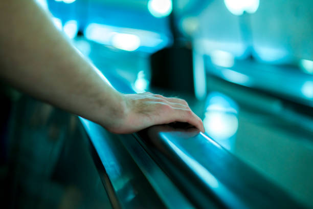 istock close up person's hand moving up on the escalator in subway 1019335564