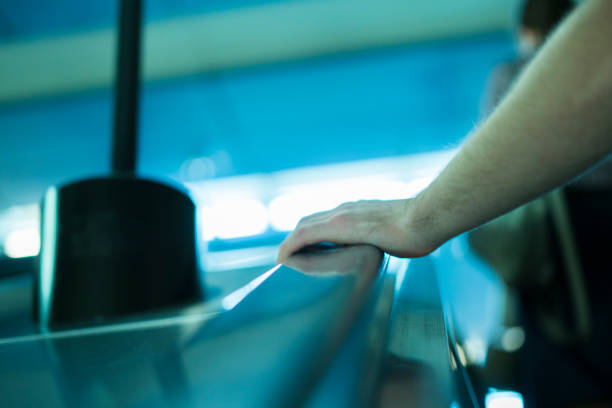 istock close up person's hand moving up on the escalator in subway 1019335590