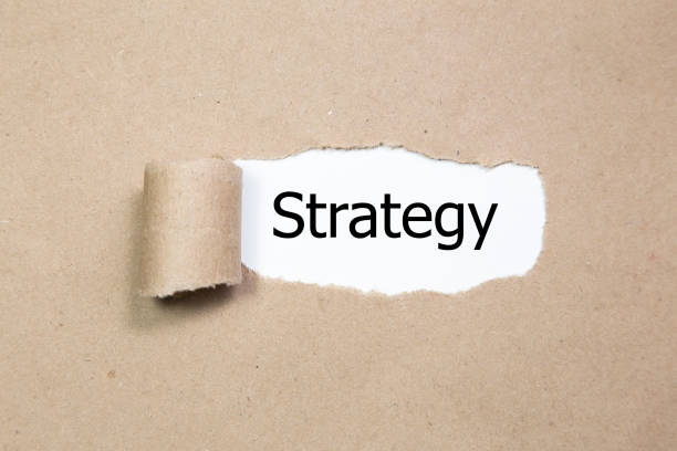 istock The word strategy appearing behind torn paper. 1019338504