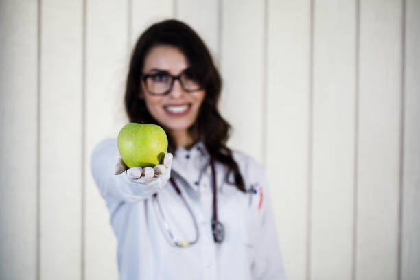 istock Nutritionist woman with green apple 1019344502
