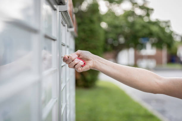 istock Woman hand Picking up the Mail at Postal Mailbox 1019355526