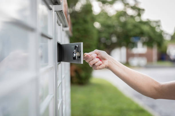 istock Woman hand Picking up the Mail at Postal Mailbox 1019355542