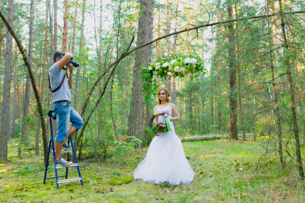 istock Wedding photographer using stepladder to make pictures of the bride 1019355666