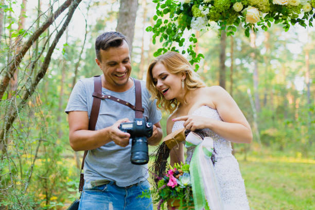 istock Photographer and bride watching recently taken photos 1019355688