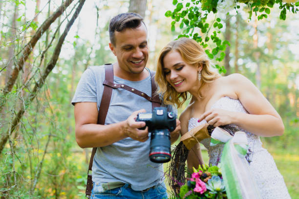 istock Photographer and bride watching recently taken photos 1019355692