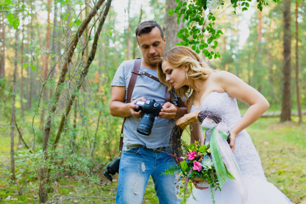 istock Photographer and bride watching recently taken photos 1019355700