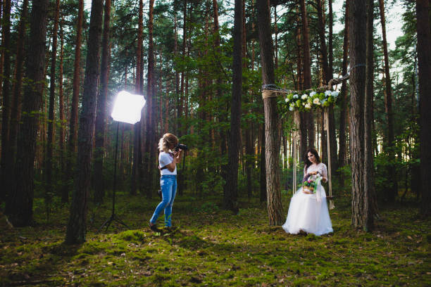 istock Professional wedding photographer using strobe and softbox to make pictures 1019355848