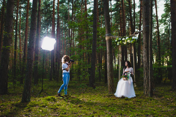 istock Professional wedding photographer using strobe and softbox to make pictures 1019355864
