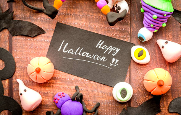 halloween symbols and decorations on wooden table flat lay top view halloween concept. symbols and decorations made of polymer clay on wooden table flat lay top view polymer clay sweets stock pictures, royalty-free photos & images
