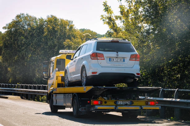 Tow truck with car on road Italy Rome, Italy - October 4, 2017: Tow truck with a car on the road towing photos stock pictures, royalty-free photos & images