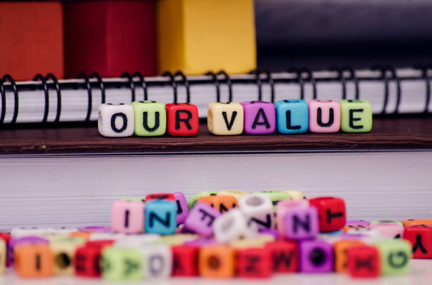 istock Business success and support concept, cube dices with word OUR VALUE on note book 1019375600