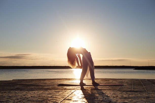istock yoga asana on the Beach 1019384760