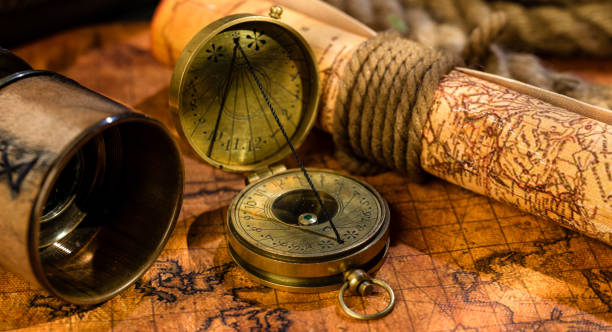 istock Old vintage retro compass and spyglass on ancient world map 1019388424
