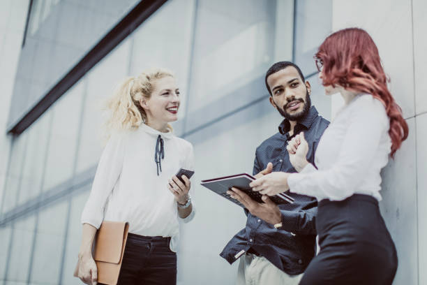 istock Business People Discussing in Front of Building 1019388708