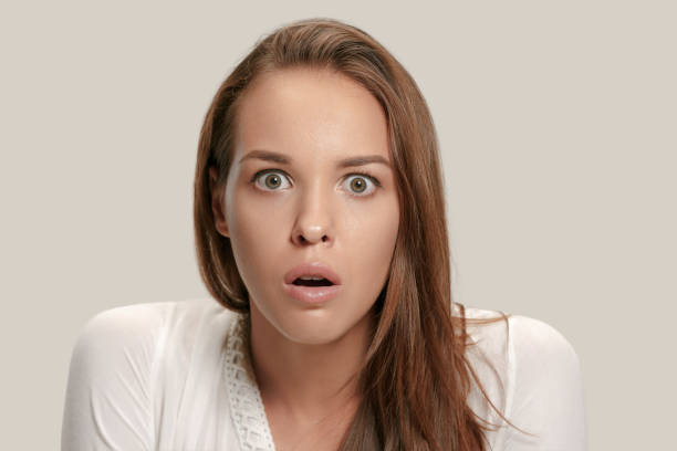 istock Beautiful woman looking suprised isolated on gray 1019389536
