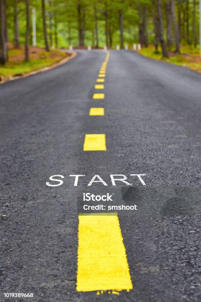 Words Of Start With Yellow Line Marking On Road Surface Stock Photo - Download Image Now