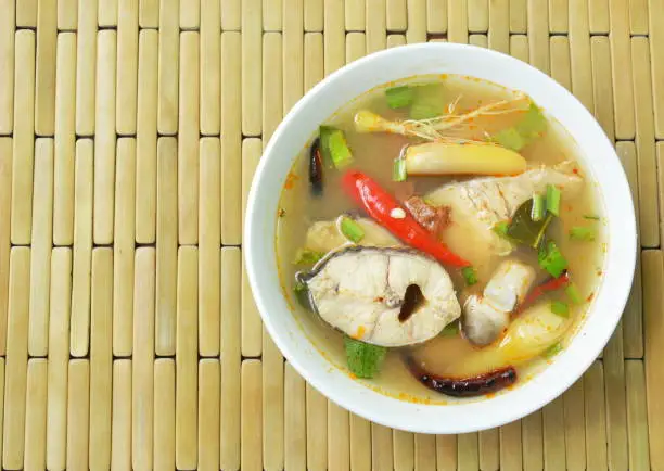 spicy boiled snake head fish and straw mushroom in tom yum soup on bowl