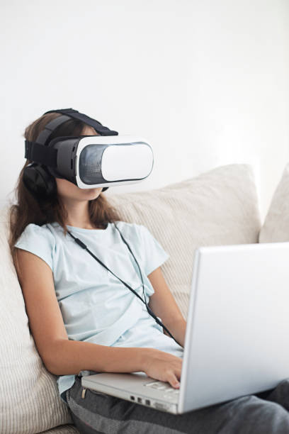 istock Girl having fun with VR headset 1019400400