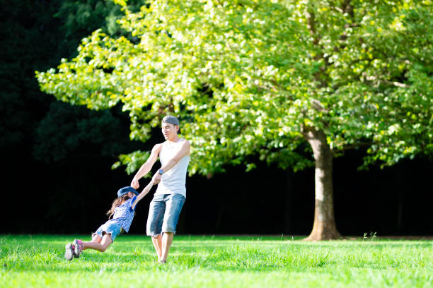 istock Father and daughter playing in the park 1019400476