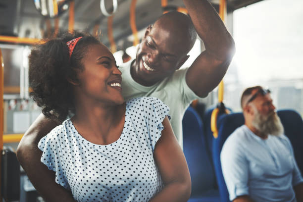istock Smiling young African couple standing affectionately together on a bus 1019412686