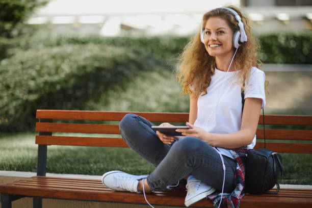 istock Young woman sitting on bench. 1019412776