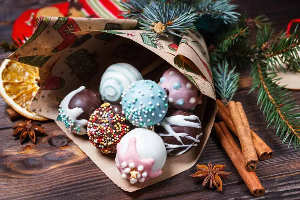 Christmas pop cakes. Sweet food. Colorful. Cinnamon, anise stars and fir branches.