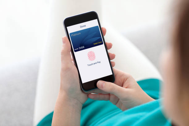 istock woman holding phone debit card app touch pay on screen 1019418980