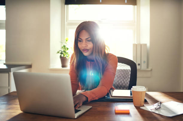 istock Young woman working on a laptop in her home office 1019423964