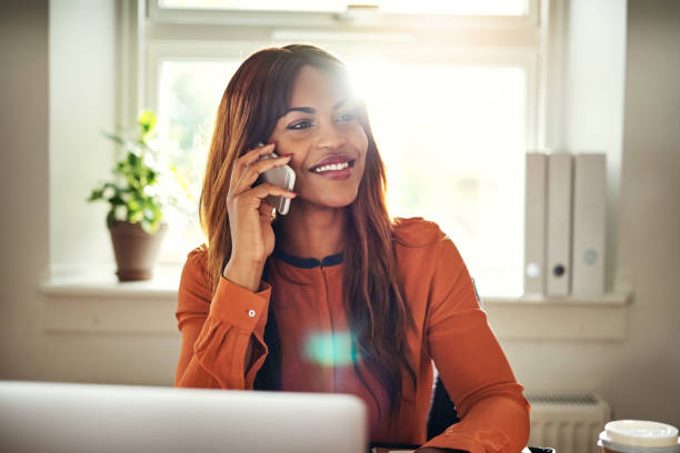 istock Smiling woman talking on a cellphone in her home office 1019423986