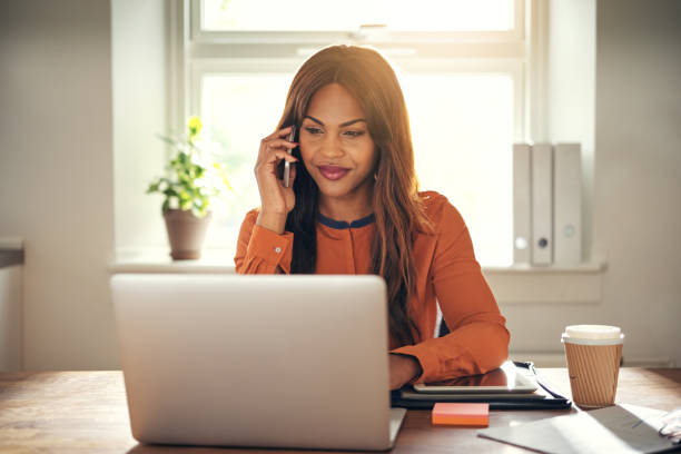 istock Young entrepreneur talking on the phone and using a laptop 1019423996