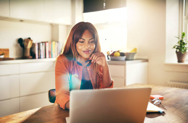 istock Successful female entrepreneur working on a laptop in her kitchen 1019424012