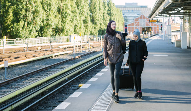 istock Two friends walking away from the train station. 1019425166