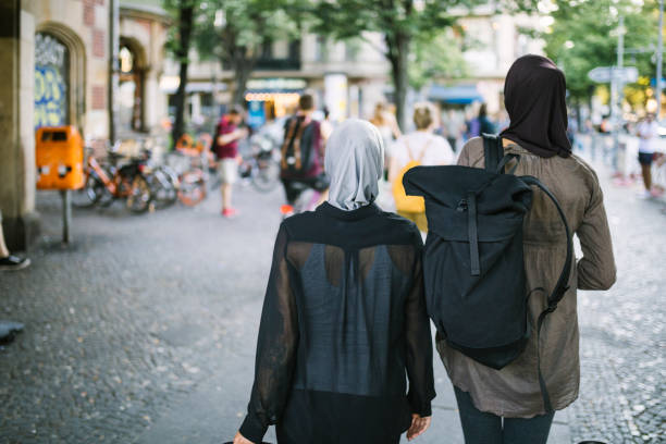 istock Two travellers walking towards old town. 1019426950