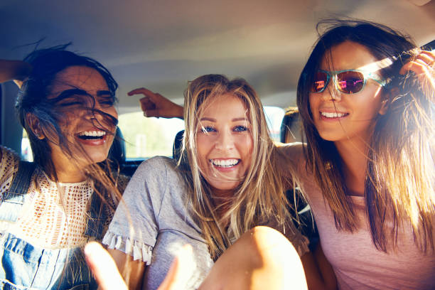 istock Three beautiful happy girls in a car 1019427260